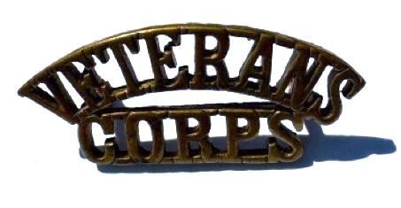 Original brass shoulder title. Veterans Corps