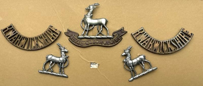 Royal Warwickshire Regiment Cap Badge, a pair of Shoulder Titles and a Pair of Collar Badges